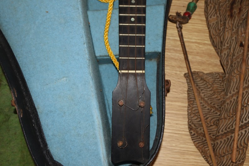 An early 20th century Saxon violin cased with bow and a cased banjo